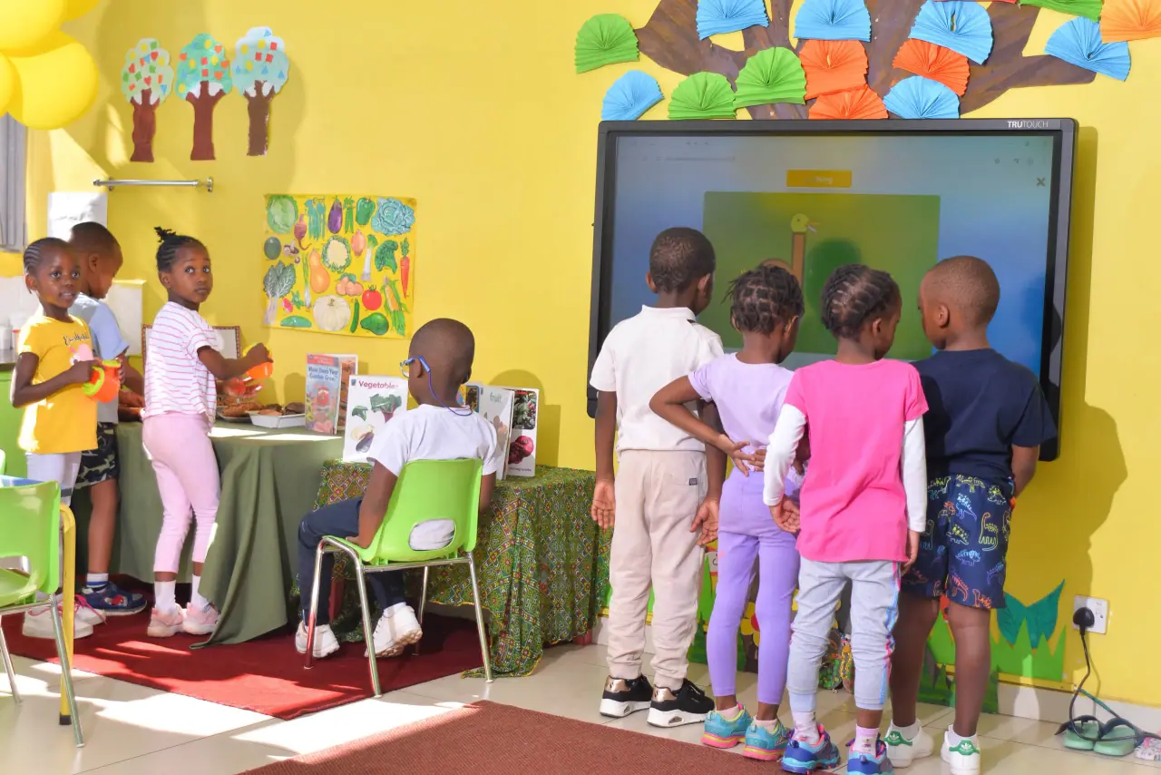 ECD children gathered at the interactive screen for storytime