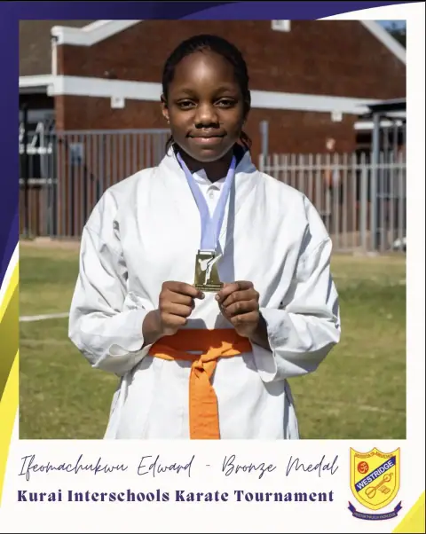 A karate student holding her medal