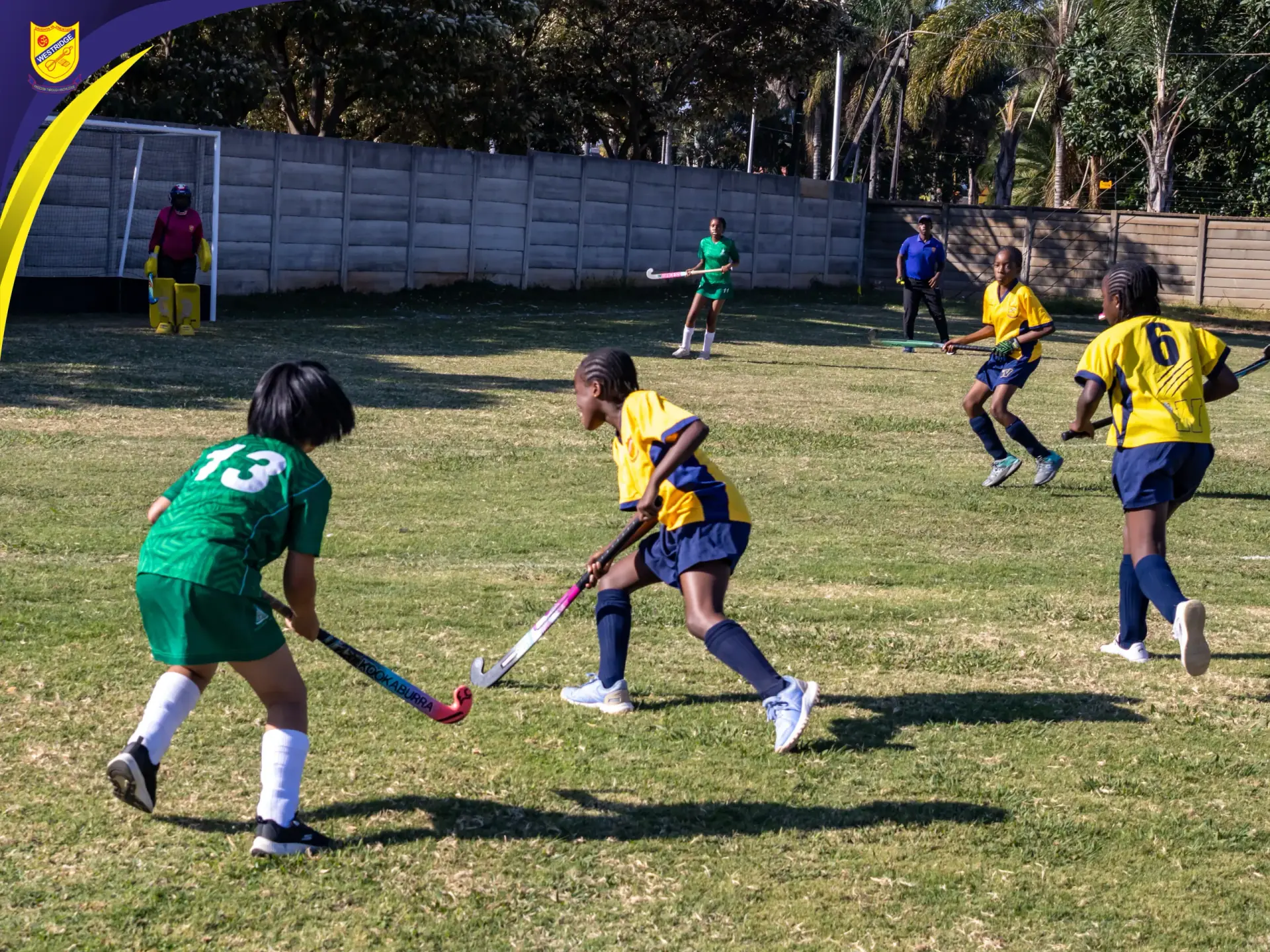 Westridge girls in yellow playing a hockey match